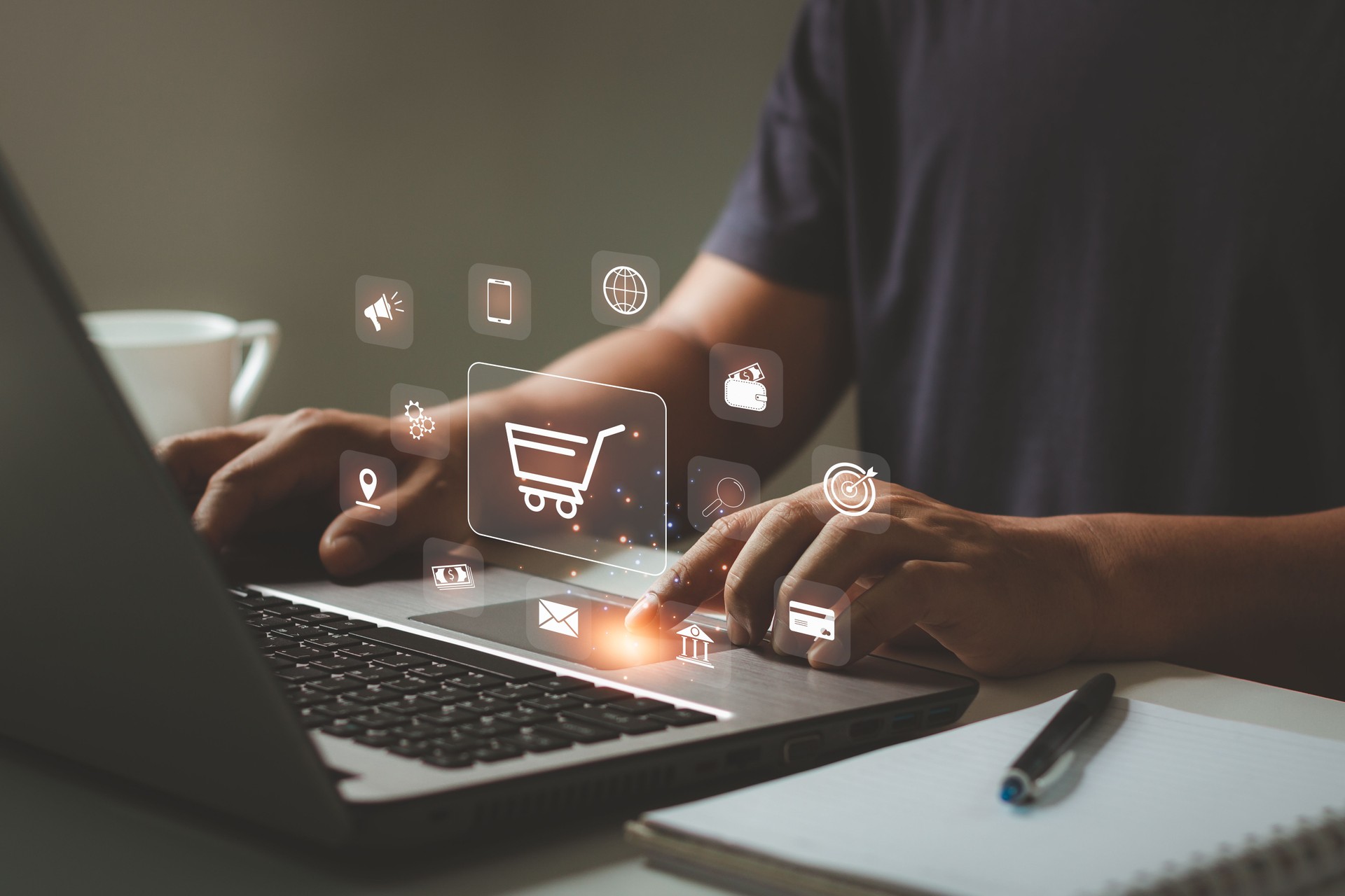 Online shopping and e-commerce concept. Young man using laptop computer with shopping cart icon, order in online store, shopping on internet, concept on virtual screen with hands typing on keyboard.